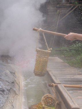 Eggs and vegetables being cooked  in  the water of hot springs in Taiping Mountain in Taiwan clipart