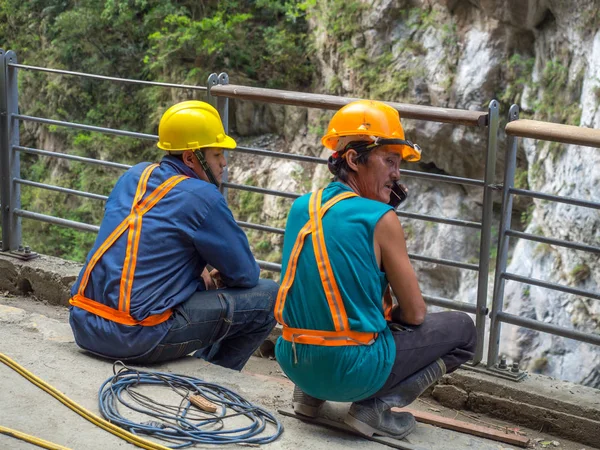 Workers at an edge of a  river — Stock Photo, Image