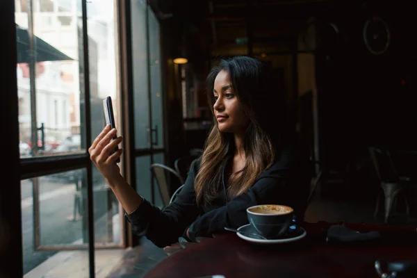Young Mixed Race Girl Taking Selfie Smartphone Sitting Table Coffee Stock Picture