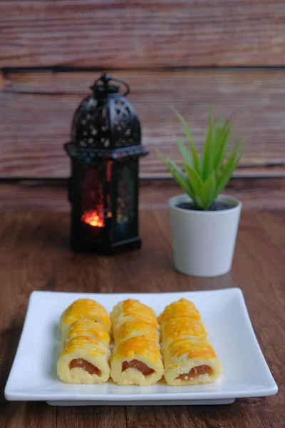 Traditional cookies in Malaysia during Hari Raya Festival known as Kuih tart or pineapples tart with lantern on the wodden background