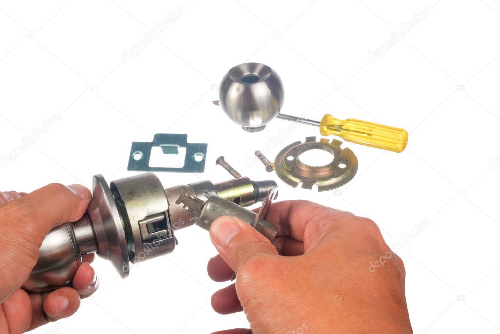 The closeup of worker hands assembling door knob isolated on white background.