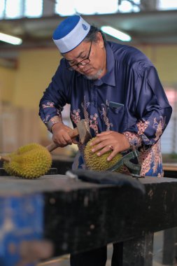 Muadzam Şah, Malezya - 25 Haziran 2020: Mutlu Asyalı erkekler arkadaşlarıyla Durian meyvesi yemekten hoşlanıyor.
