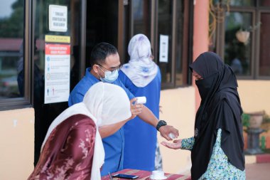 Muadzam Şah, Malezya - 29 Haziran 2020: Yeni normal, el dezenfektanı, sağlık hizmetleri ve covid-19 önleme kavramı kullanan iş adamları