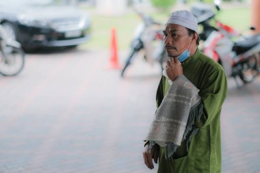 Muadzam Şah, Malezya - 3 Temmuz 2020: Müslümanlar Covid-19 salgını sırasında Muadzam Şah Camii 'nde Cuma namazı kıldılar. İnsanlar terlik / ayakkabı deposu için plastik ya da çanta taşımalıdır..