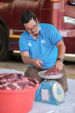 Muadzam Şah, Malezya - 10 Ağustos 2020: Keskin bir bıçakla et yığını oyan kimliği belirsiz adam