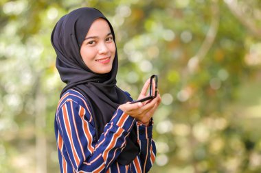 Tesettürlü, kozmetik kapaklı ve kameraya bakan yakın plan kadın modeli. Moda ve güzellik konsepti