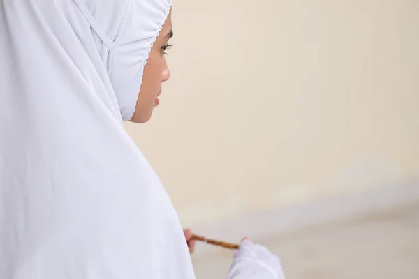 伝統的なイスラムビーズを手に女性を祈り モスクでひざまずいて — ストック写真
