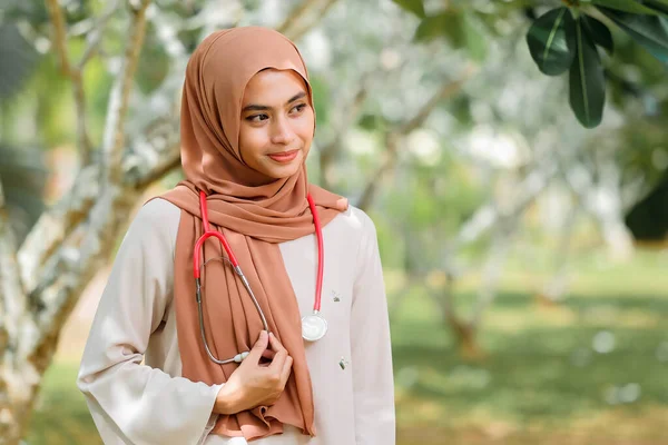 Porträtt Leende Kvinnliga Läkare Som Håller Stetoskop Stående Mot Träd — Stockfoto