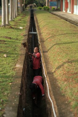Muadzam Şah, Malezya - 1 Ekim 2020: Kimliği belirsiz işçiler gideri temizliyor. Kanalizasyon sisteminde sorun var.