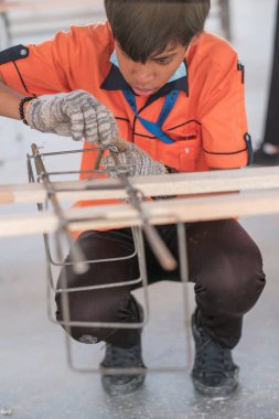 Muadzam Şah, Malezya - 29 Eylül 2020: Konut İnşaat stajyeri atölyede demir parmaklıkları bağlıyor.