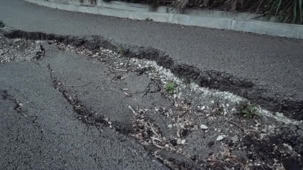 Flight above a big crack on the asphalt. — Stock Video