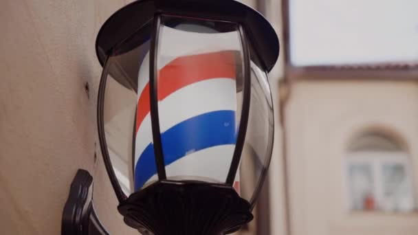 Vintage barber shop sign with rotating stripes close-up