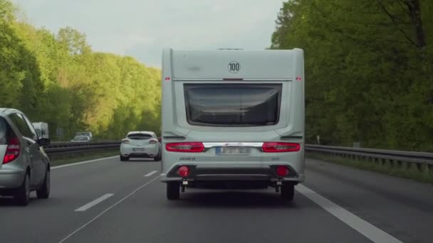 Motorhome on motorway in tourist traffic. Vacation travel with the camper. Germany. Back view — Stock Video