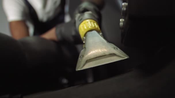 Shooting close up of a professional vacuum cleaner to clean the mat, a man cleans the car mat — Stock Video