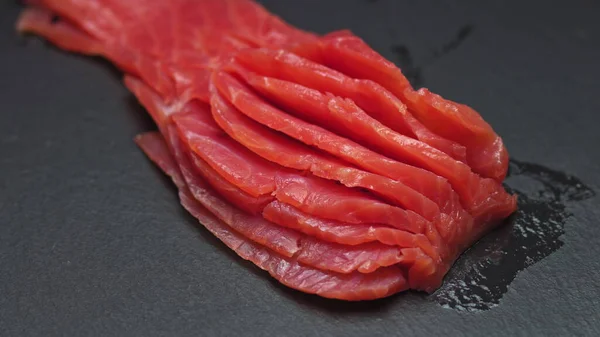 Chef takes out bones from the salmon fillet, cutting fish on slices for cooking sushi in 4k resolution in slow motion — Stock Photo, Image