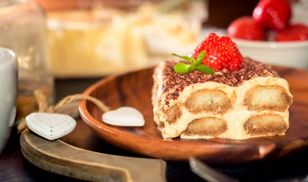 Homemade tiramisu cake decorated with strawberries Italian cuisine, Selective focus