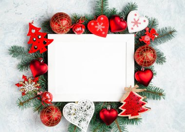 Noel ve yeni yıl çerçeve kompozisyon. Noel süslemeleri boş kopya alanı metin için beyaz zemin üzerine kırmızı renklerde. Kartpostal veya davet için tatil ve kutlama kavramı.