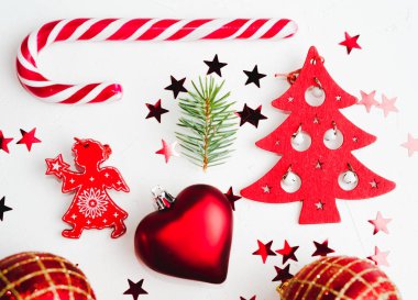 Beyaz zemin üzerine kırmızı Noel dekorasyonu. Üstten görünüm