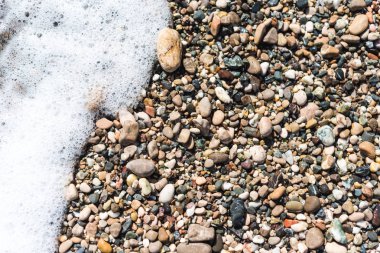 Deniz taşları arka plan deseni ve deniz köpüğü