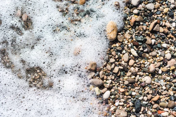 Tengeri kövek háttér mintázat és a tengeri hab — Stock Fotó
