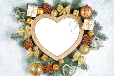 Bir kalp şeklinde Noel çerçevesi bir yeni yıl ağacı Noel süslemeleri dalları ile çevrilidir, kopya alanı ile beyaz arka planda Izole. Üst görünüm, düz yatıyordu