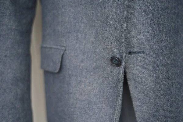 Close-up of a button on a blue business jacket