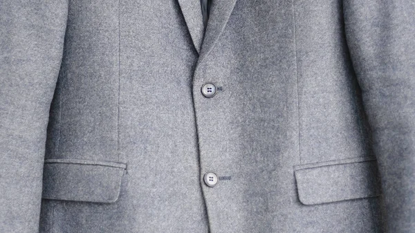 Close-up of a button on a blue business jacket