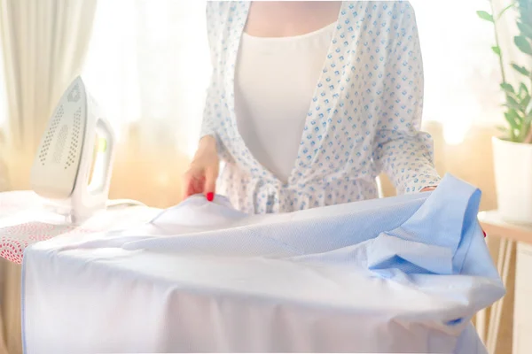 Woman ironing clothes, blue colors, home decor — Stock Photo, Image