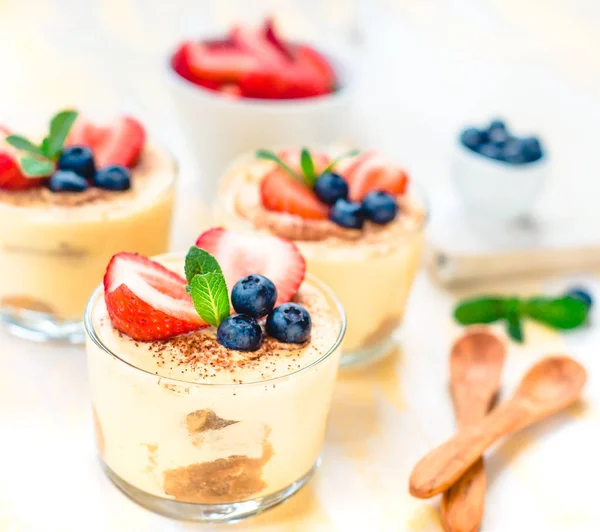 Dessert tiramisu in glazen, versierd met bosbessen, strawberrys en Mint, het concept van heerlijk leven — Stockfoto