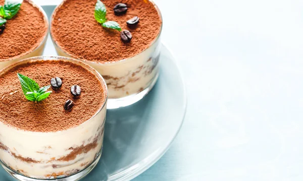 Tiramisu in the glass decorated whith mint on the wooden background — Stock Photo, Image