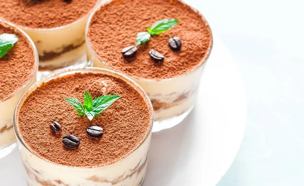 Tiramisu in the glass decorated whith mint on the wooden background — Stock Photo, Image