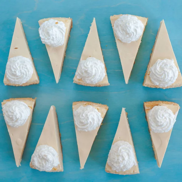 Cheesecake vzor, servírování tvarohového koláče na modrém pozadí horní pohled — Stock fotografie
