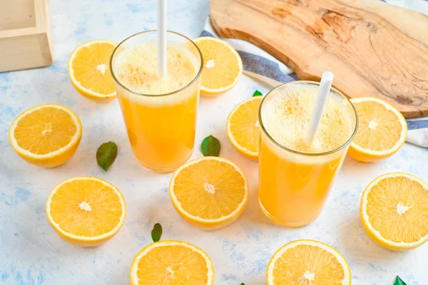 orange juice in a glass, top view, slices of oranges, straw