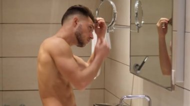 Gömleksiz kas yakışıklı genç adam saç sabitleme