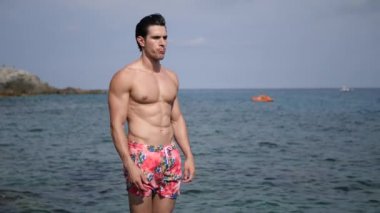 Yakışıklı genç uygun adam, kahkaha içine patlama, arkasında deniz, büyük boşaltmak