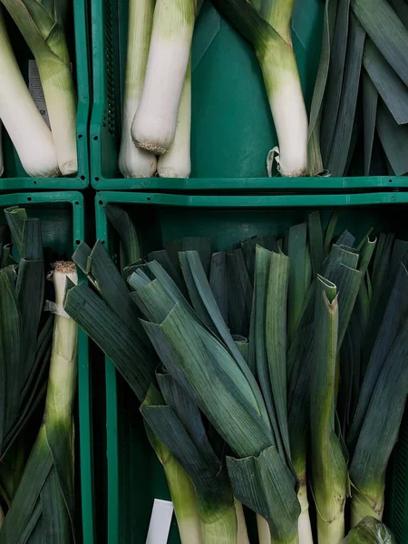 Leeks in a green box on the market