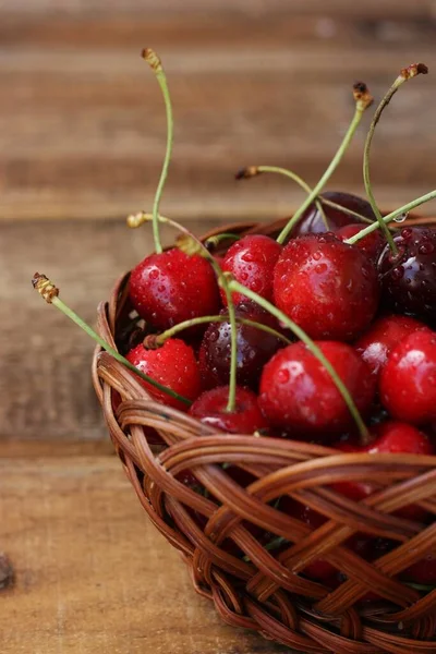Ripe red cherries on a wooden table