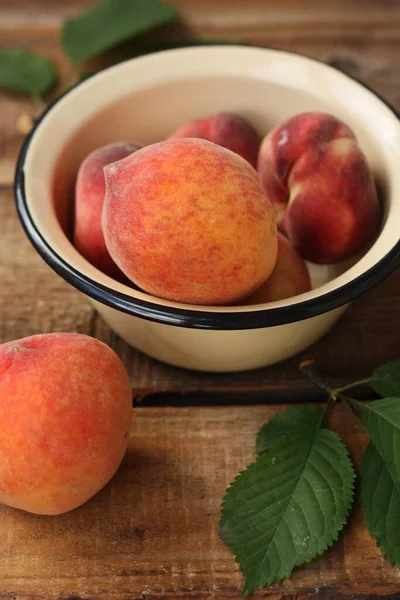 Juicy peaches on a wooden table macro