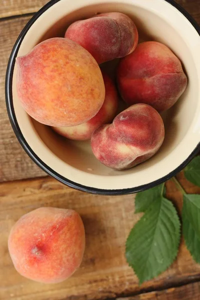 Juicy peaches on a wooden table macro