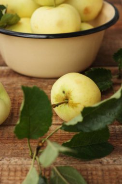 Masada yaprakları olan lezzetli yeşil elmalar.