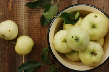 Masada yaprakları olan lezzetli yeşil elmalar.