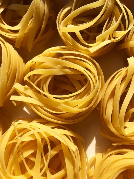 Tagliatelle pasta in a white box macro