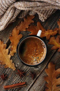 Amerikan kahvesi ve meşe yaprakları masanın üstünde.