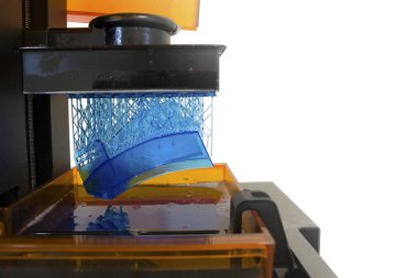 Working 3D printer. Electronic three dimensional printing machine in process.