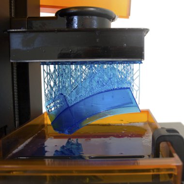 Working 3D printer. Electronic three dimensional printing machine in process.