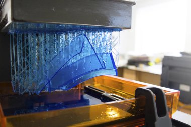 Working 3D printer. Electronic three dimensional printing machine in process.