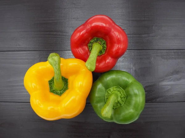 Fresh vegetables, red, yellow, green sweet peppers on white background.