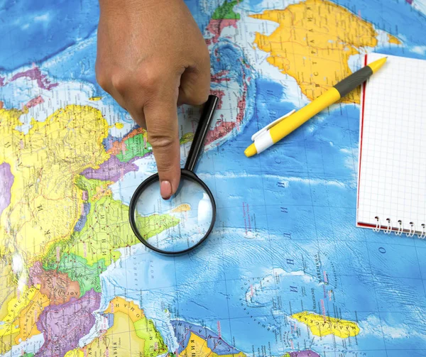 Search for new bright places to travel on the map and looking at the magnifying glass