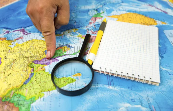 Search for new bright places to travel on the map and looking at the magnifying glass