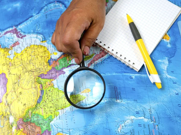 Search for new bright places to travel on the map and looking at the magnifying glass